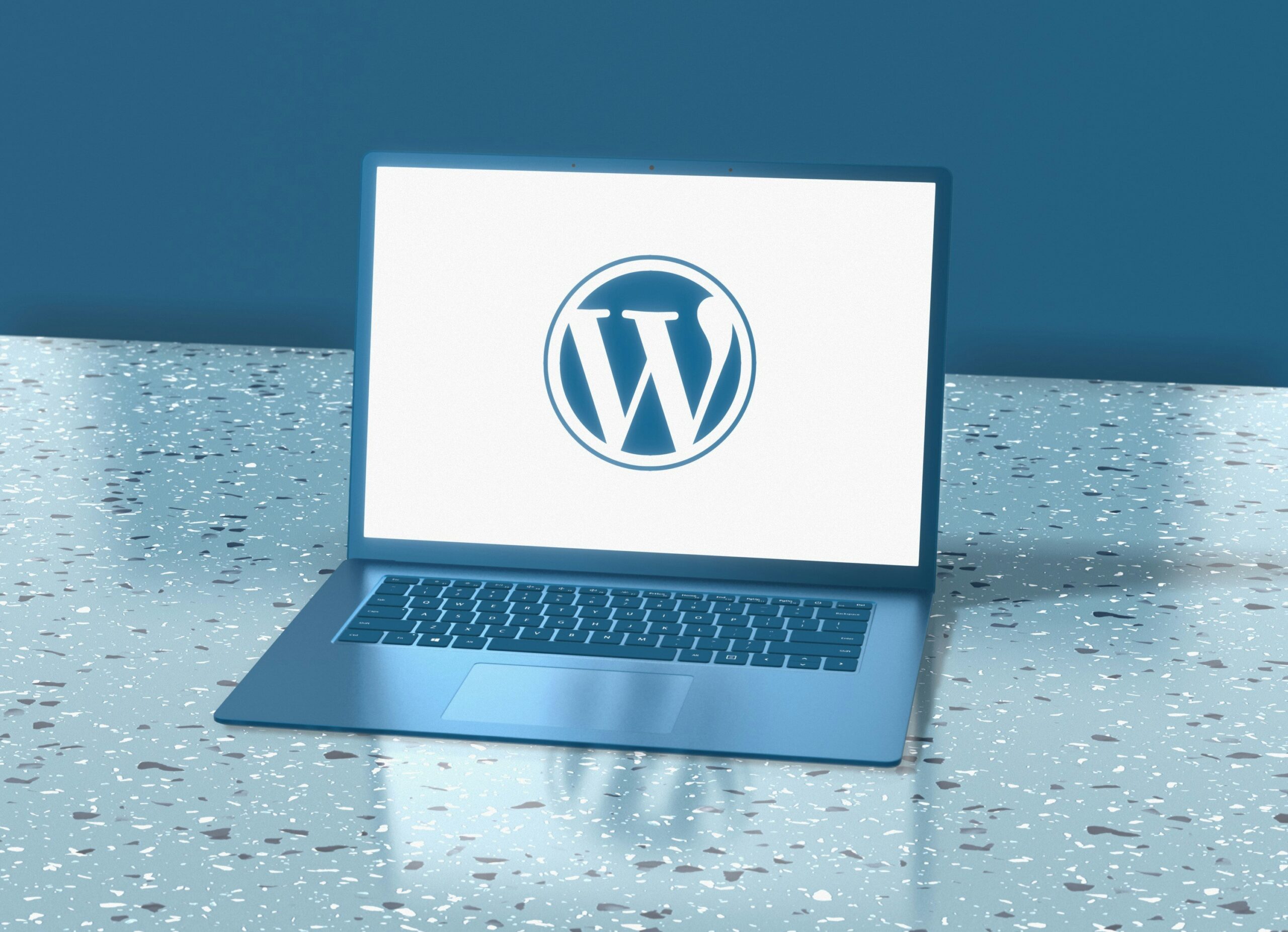 Laptop displaying the WordPress logo, representing managed WordPress hosting services